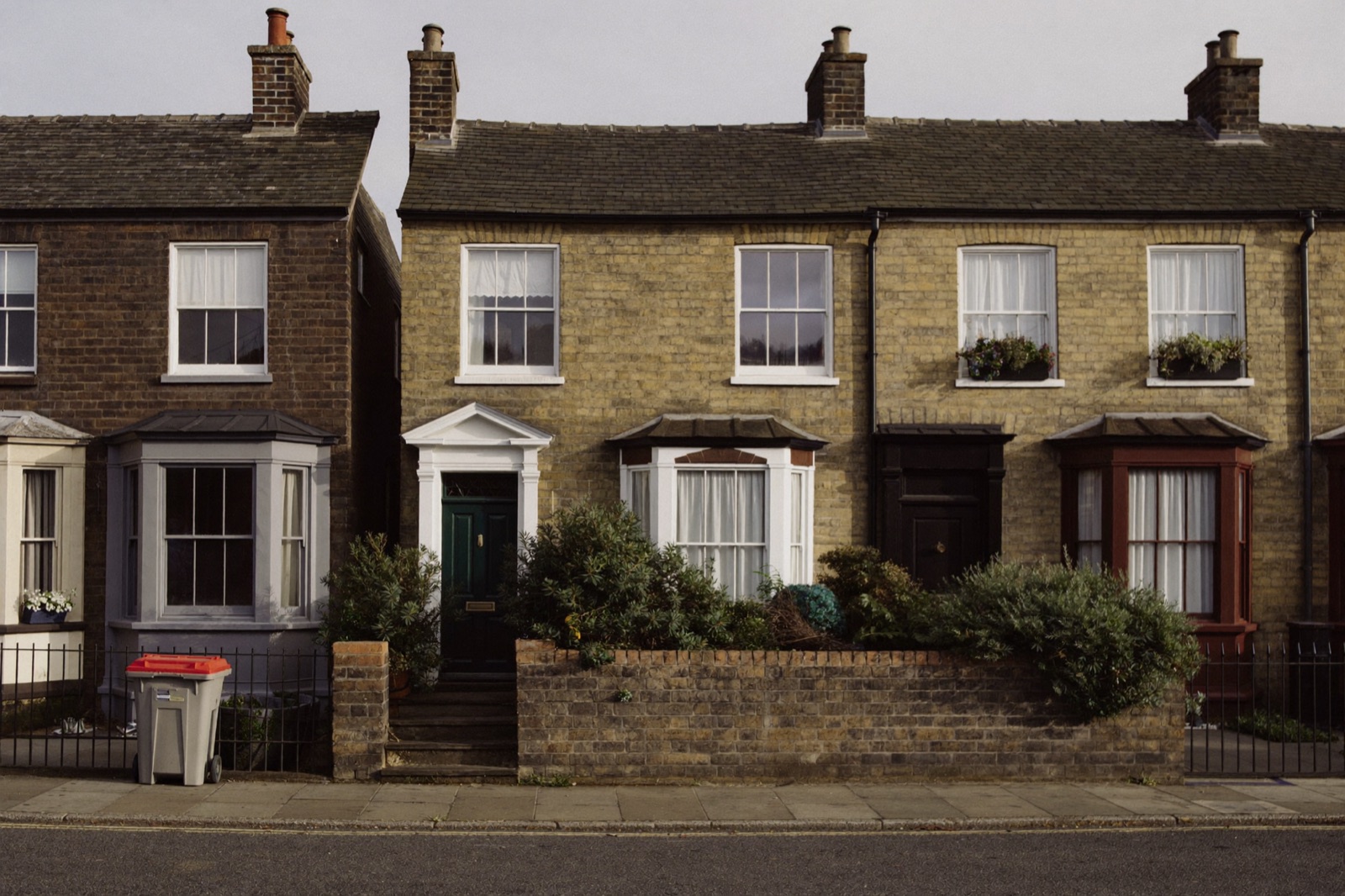 A modest Victorian terraced house in a row on an ordinary English street.