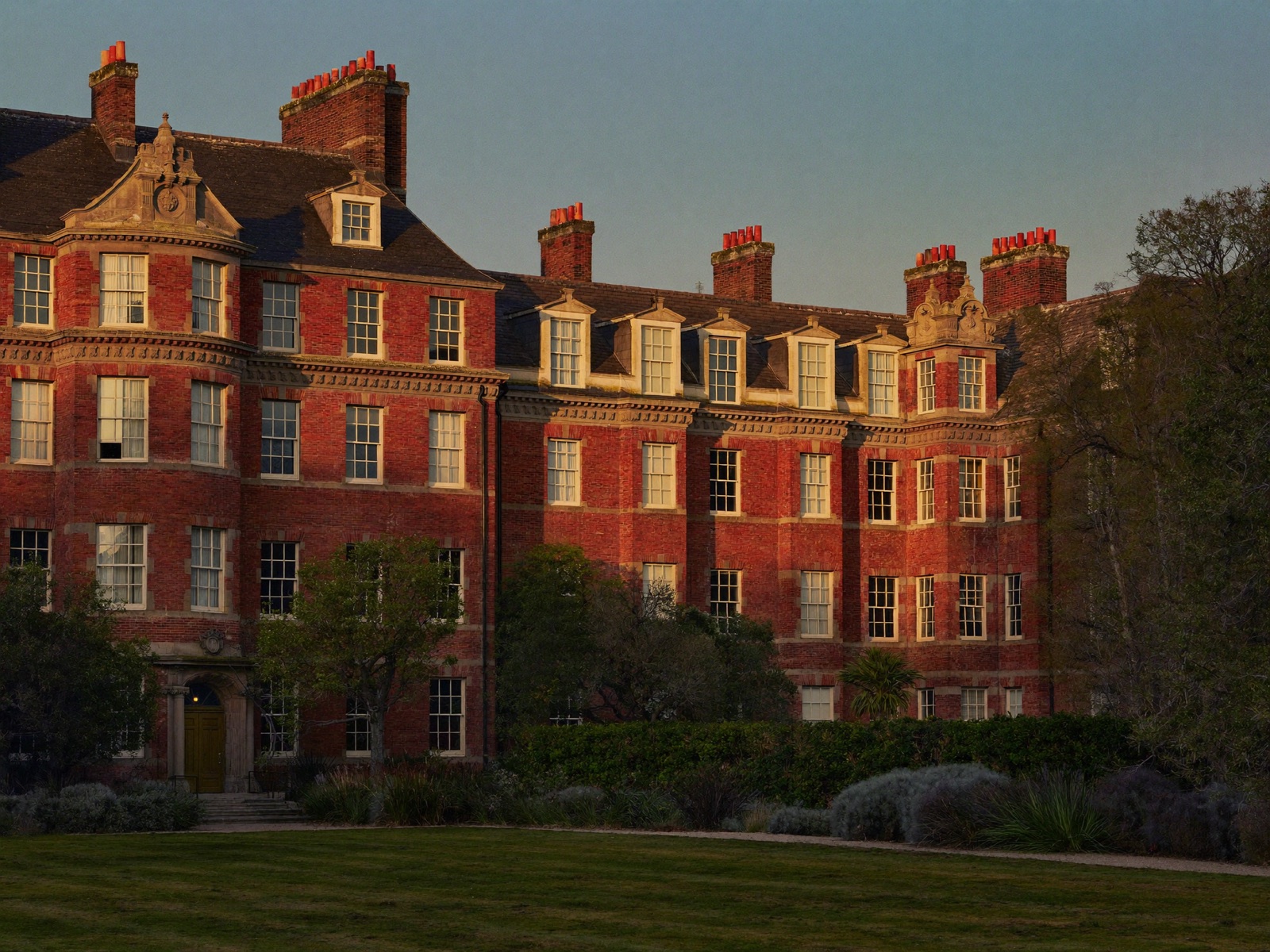 An Edwardian red-brick mansion block of flats at golden hour.